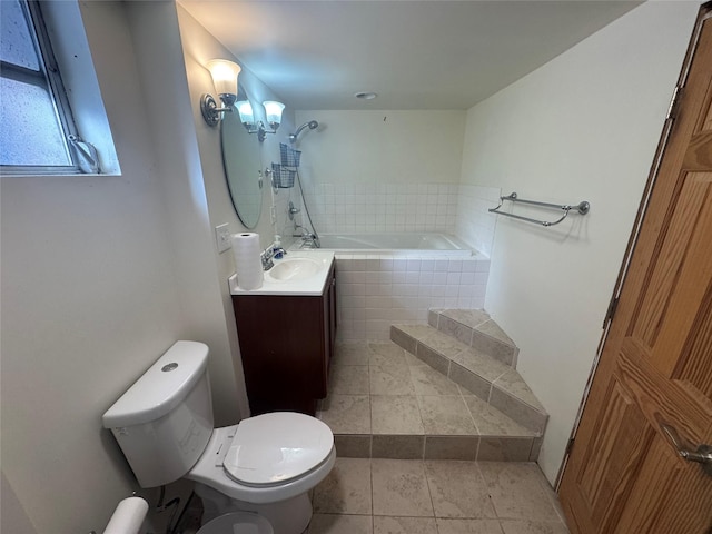 bathroom with tile patterned flooring, vanity, a relaxing tiled tub, and toilet