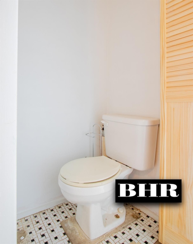 bathroom featuring tile patterned flooring and toilet