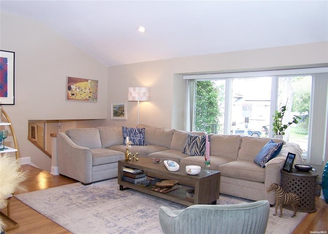 living room with hardwood / wood-style flooring and vaulted ceiling