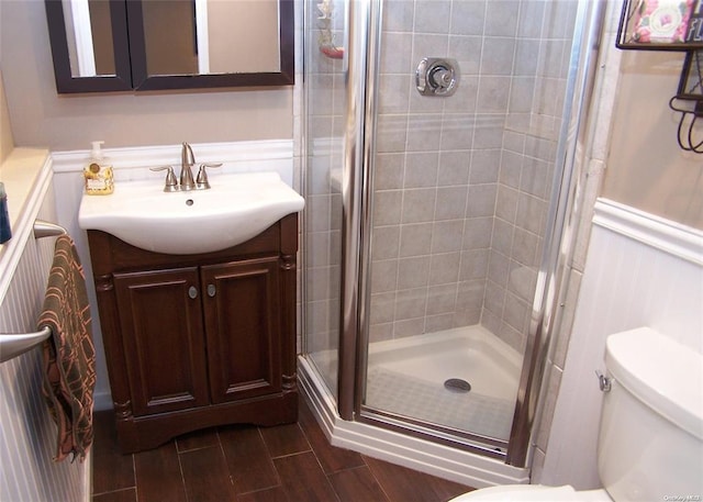 bathroom with vanity, toilet, and walk in shower