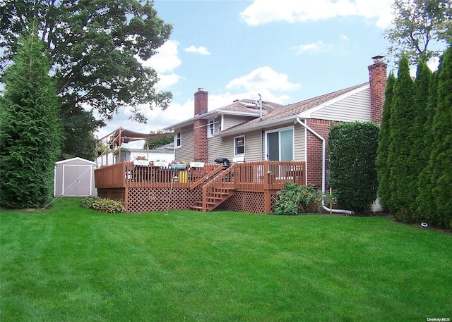 rear view of house featuring a lawn, a storage shed, and a wooden deck