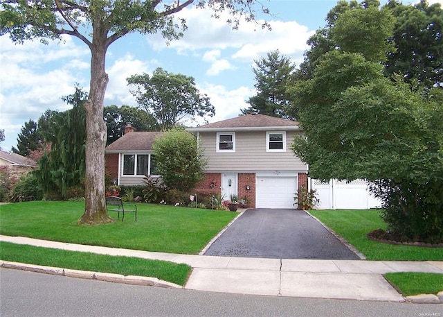 view of front of house featuring a garage and a front lawn