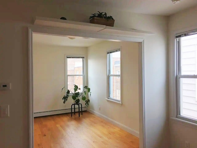 interior space with light hardwood / wood-style flooring and a baseboard radiator