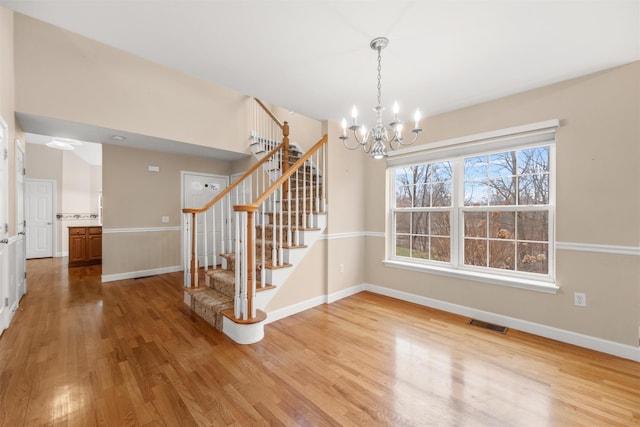 interior space with hardwood / wood-style floors and a chandelier