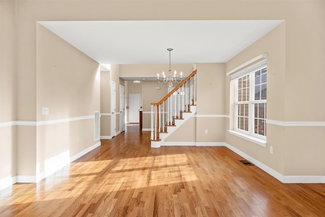 entryway featuring a chandelier and hardwood / wood-style flooring