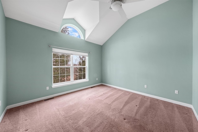 carpeted empty room with ceiling fan and vaulted ceiling