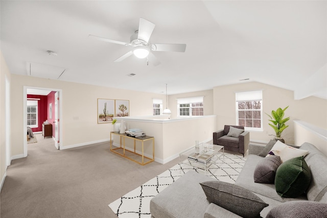 carpeted living room with ceiling fan and lofted ceiling