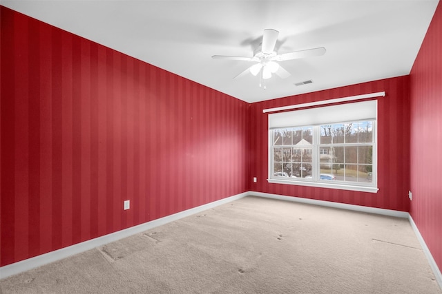 spare room featuring carpet floors and ceiling fan