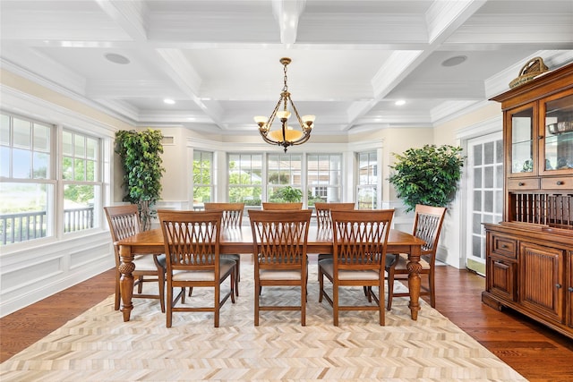 dining area featuring a chandelier, beam ceiling, light hardwood / wood-style floors, and coffered ceiling