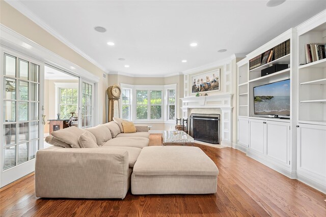 living room featuring light hardwood / wood-style floors and crown molding