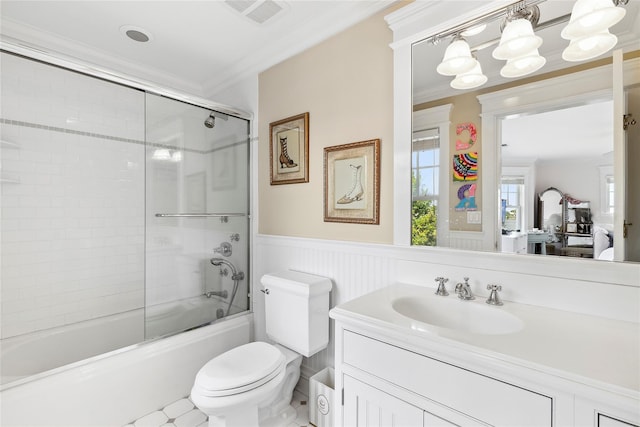 full bathroom with crown molding, vanity, enclosed tub / shower combo, and toilet