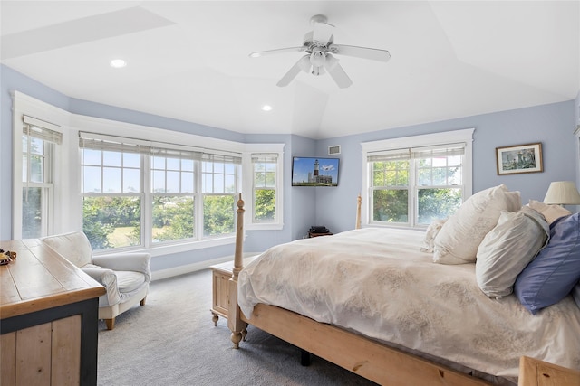 bedroom featuring multiple windows, light colored carpet, and ceiling fan