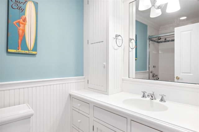 full bathroom featuring toilet, vanity, tiled shower / bath combo, and ornamental molding