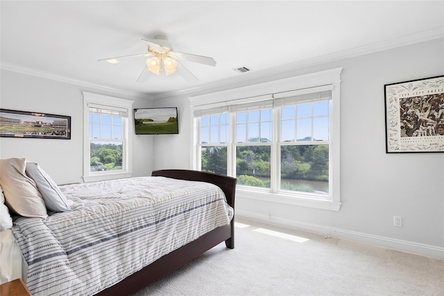 bedroom with carpet floors, ceiling fan, and crown molding