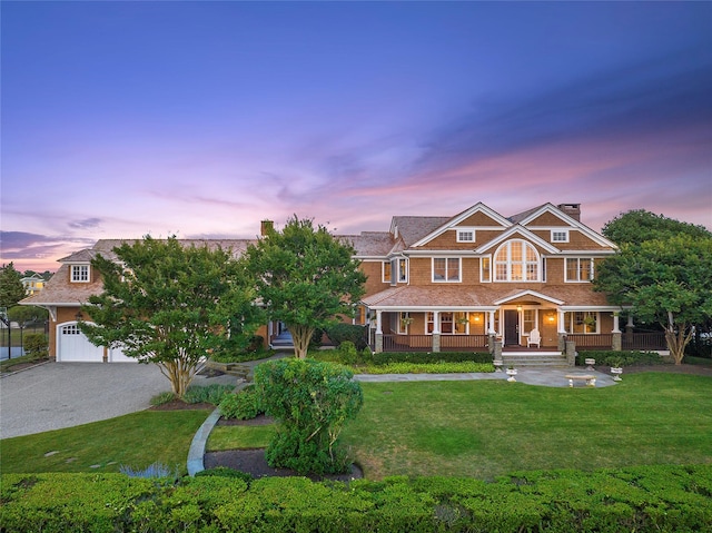 view of front of home featuring covered porch and a yard