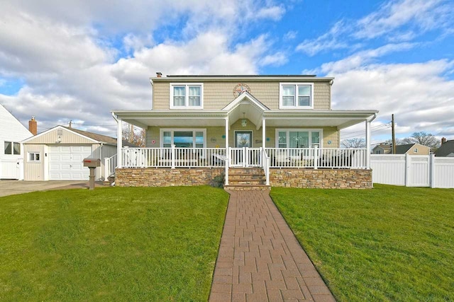 view of front facade featuring covered porch, a garage, a front lawn, and an outdoor structure