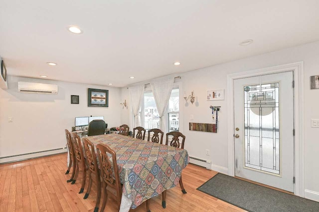 dining space with light wood-type flooring, baseboard heating, and a wall unit AC