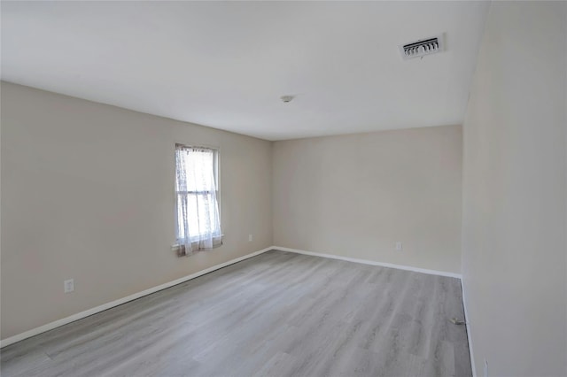 unfurnished room with light wood-type flooring