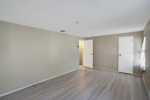 unfurnished room with light hardwood / wood-style flooring