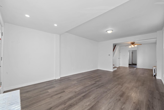 empty room with ceiling fan and dark hardwood / wood-style flooring