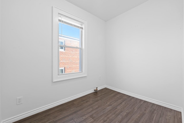 empty room with dark hardwood / wood-style flooring