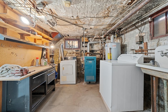 basement featuring independent washer and dryer, a workshop area, and water heater