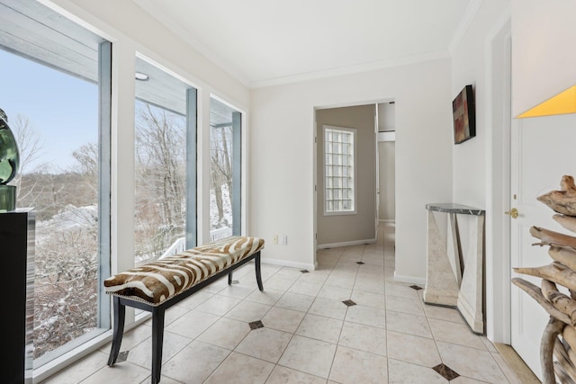 interior space with light tile patterned floors, ornamental molding, and baseboards