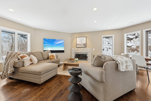 living area with a high end fireplace, dark wood-style flooring, and recessed lighting