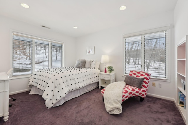 bedroom with carpet floors, multiple windows, visible vents, and baseboards