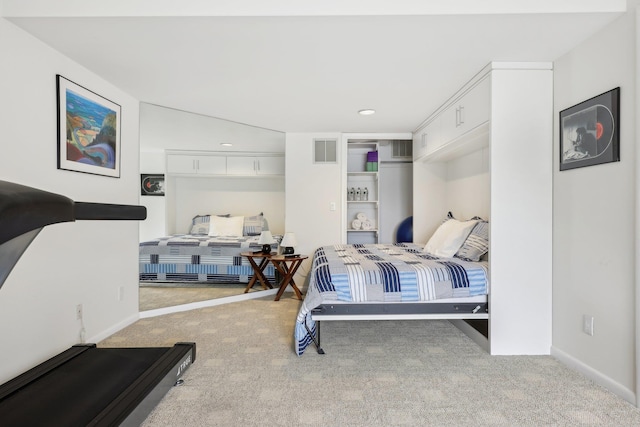 carpeted bedroom with visible vents and baseboards