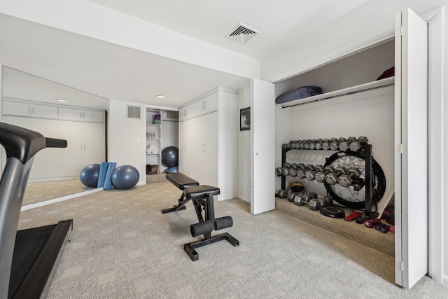 exercise area featuring visible vents and carpet flooring