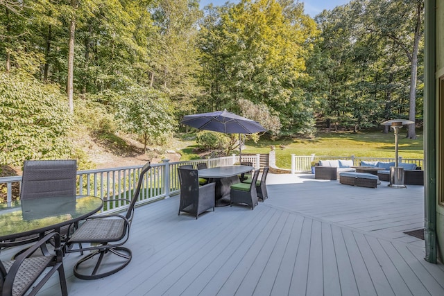 wooden deck featuring outdoor lounge area, outdoor dining area, and a lawn