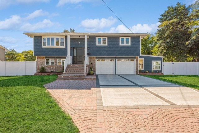 raised ranch featuring a front yard and a garage