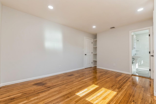 spare room featuring light hardwood / wood-style flooring