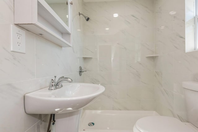 bathroom with tiled shower, tile walls, and toilet