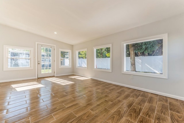 unfurnished room featuring lofted ceiling