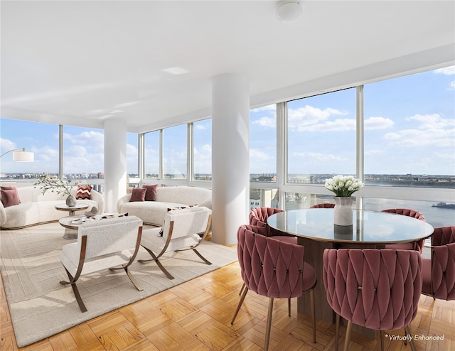 sunroom / solarium featuring a water view and a healthy amount of sunlight