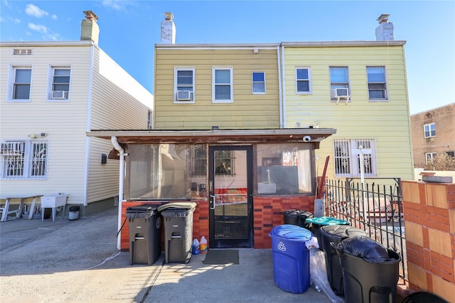 back of house featuring a sunroom