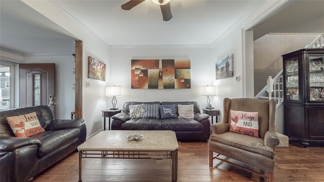 living room with crown molding, ceiling fan, and wood-type flooring