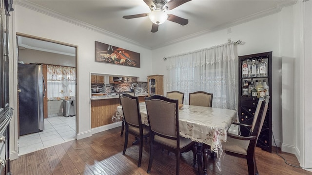 dining area featuring ceiling fan, wood-type flooring, and crown molding