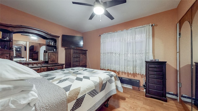 bedroom with ceiling fan and light hardwood / wood-style floors