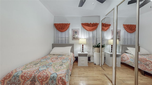 bedroom featuring a closet, light hardwood / wood-style flooring, and ceiling fan