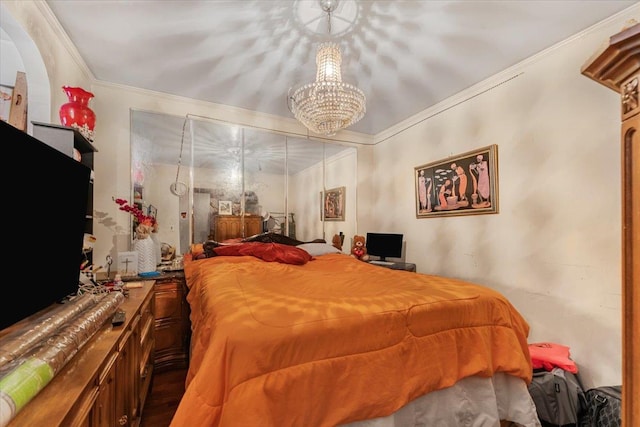 bedroom featuring crown molding and an inviting chandelier