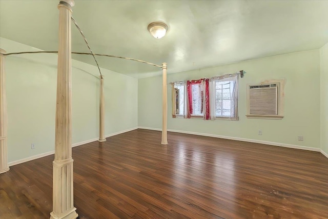 interior space featuring a wall mounted air conditioner and dark wood-type flooring