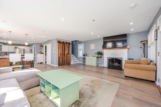 living room featuring a fireplace and light wood-type flooring