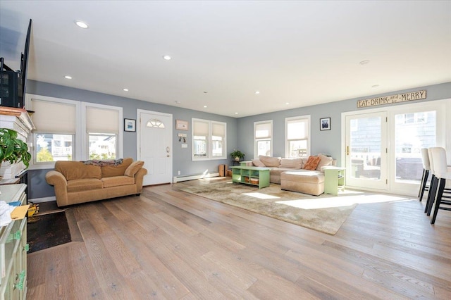 living room with a baseboard radiator and light hardwood / wood-style floors