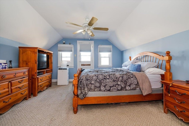 bedroom with ceiling fan, light carpet, and vaulted ceiling