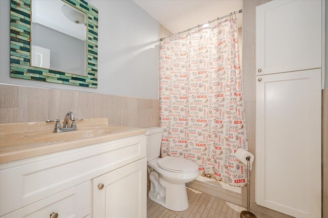 bathroom featuring tile patterned flooring, vanity, and toilet