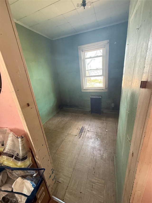 interior space featuring crown molding and radiator