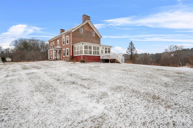 back of property with a sunroom